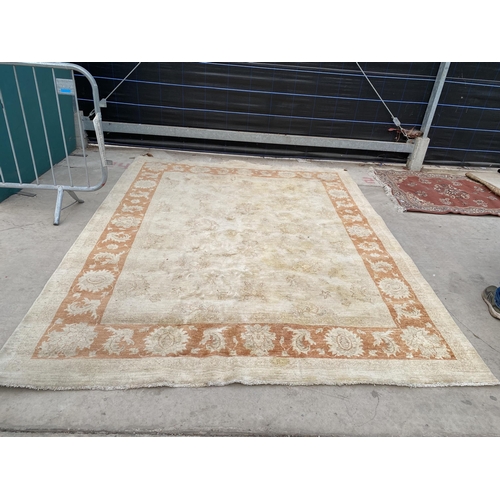 2192 - A LARGE CREAM AND ORANGE RUG