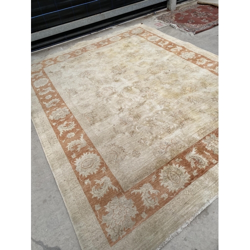 2192 - A LARGE CREAM AND ORANGE RUG