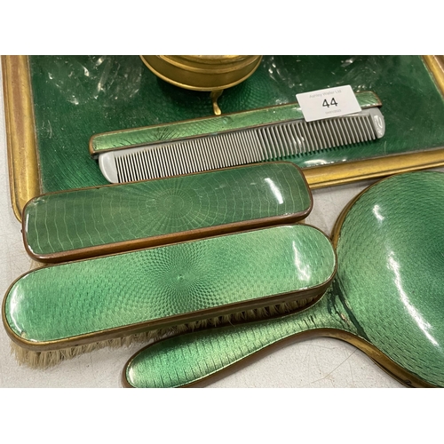 44 - A VINTAGE GREEN ENAMEL BACKED DRESSING TABLE SET COMPRISING TRAY, BRUSHES, MIRROR AND POTS