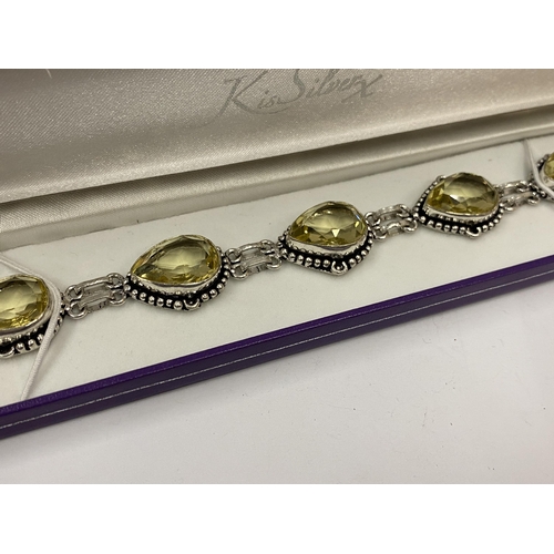 149 - A BOXED SILVER AND YELLOW STONE BRACELET