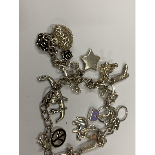 151 - A SILVER CHARM BRACELET AND CHARMS