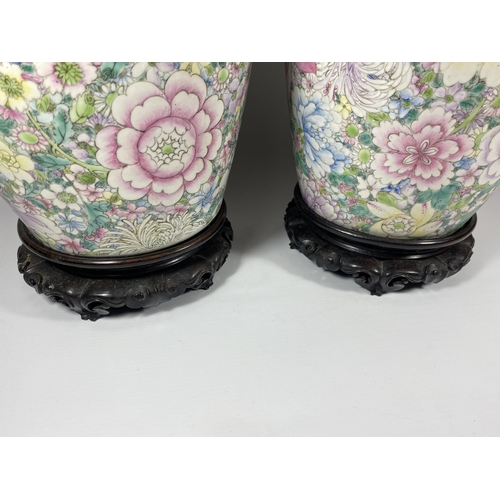 321 - A PAIR OF LATE 19TH CENTURY CHINESE QING FLORAL DESIGN LIDDED JARS ON WOODEN STANDS, QIANLONG MARK T... 