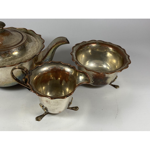 96 - A VINTAGE SILVER PLATE ON COPPER THREE PIECE TEA SET