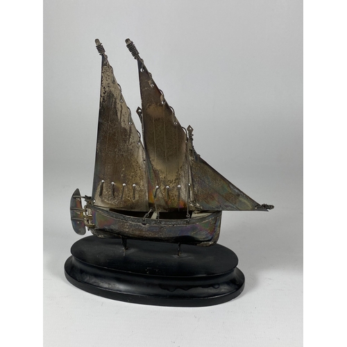 548 - A SILVER STAMPED MODEL OF A SHIP ON WOODEN BASE