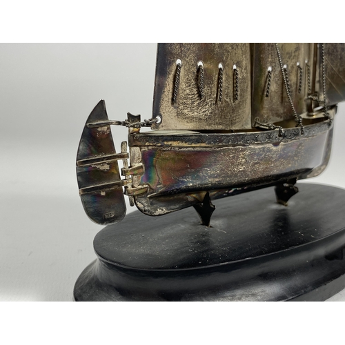 548 - A SILVER STAMPED MODEL OF A SHIP ON WOODEN BASE