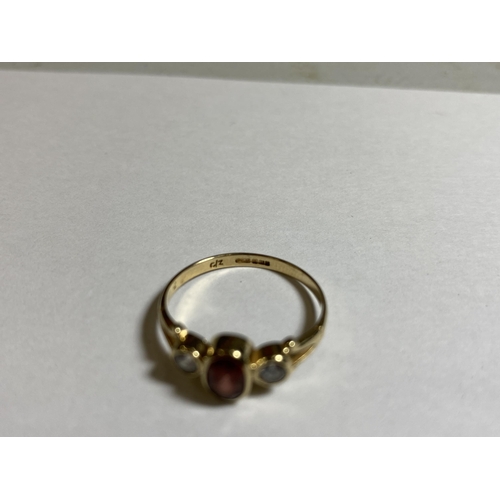 606 - A 9CT YELLOW GOLD GARNET AND CZ RING, WEIGHT 1.6G