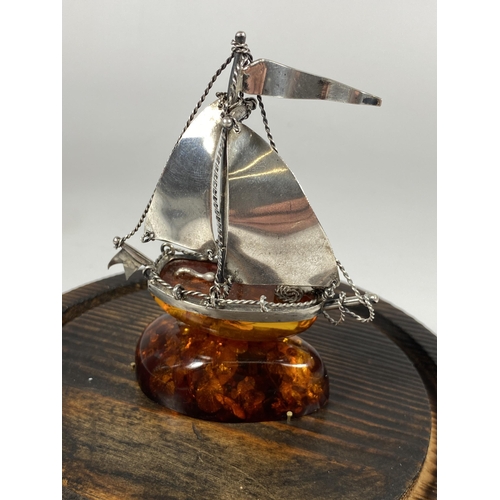 654 - A BALTIC AMBER & SILVER SHIP MODEL IN A GLASS DOME