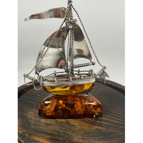 654 - A BALTIC AMBER & SILVER SHIP MODEL IN A GLASS DOME