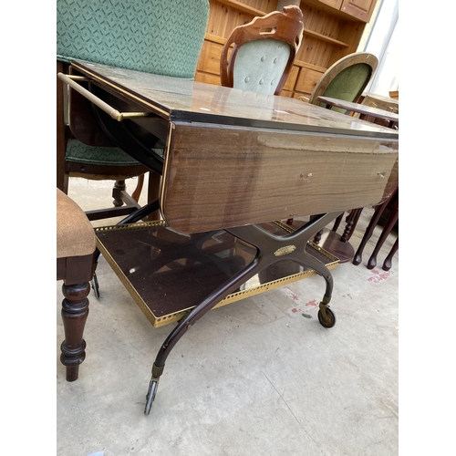 2304 - A 1960'S TWO TIER MAHOGANY TROLLEY ON X-FRAME WITH BRASS GALLERY TO THE LOWER TIER AND BRASS HANDLES