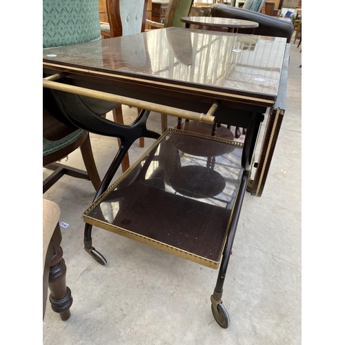 2304 - A 1960'S TWO TIER MAHOGANY TROLLEY ON X-FRAME WITH BRASS GALLERY TO THE LOWER TIER AND BRASS HANDLES