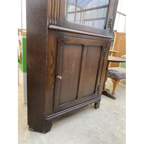 2313 - A MODERN OAK GLAZED CORNER CUPBOARD WITH CUPBOARD TO THE BASE