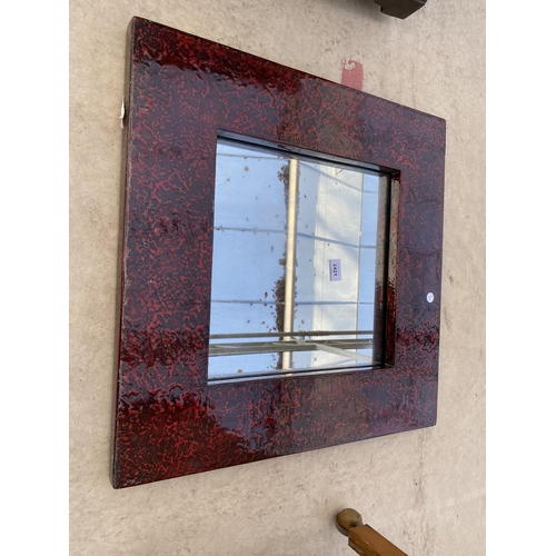 2421 - A MODERN WALL MIRROR WITH RED EMBOSSED FRAME, 23.5