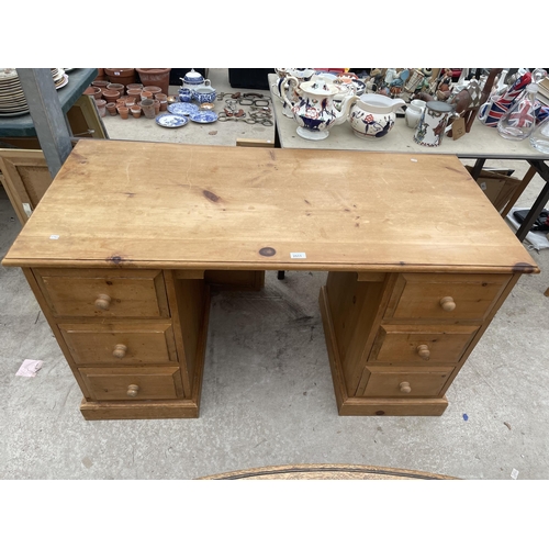 2511 - A PINE KNEEHOLE DESK WITH SIX DRAWERS