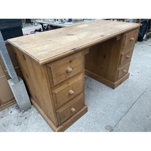 2511 - A PINE KNEEHOLE DESK WITH SIX DRAWERS