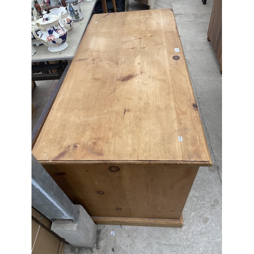 2511 - A PINE KNEEHOLE DESK WITH SIX DRAWERS