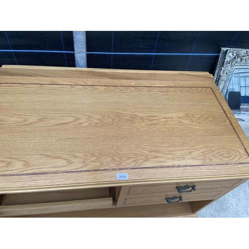 2535 - AN OAK CABINET WITH TWO DRAWERS AND SLIDE OUT SHELF