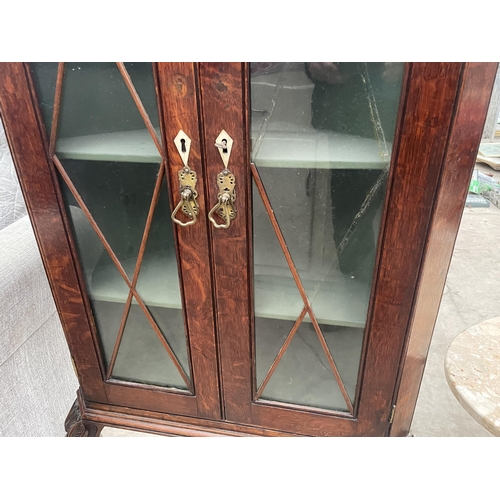 2579 - A VICTORIAN OAK TWO DOOR GLAZED CORNER CUPBOARD ON OPEN BASE, 28