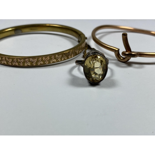 574 - THREE ITEMS - A SILVER AND CITRINE STYLE STONE RING AND TWO GOLD PLATED BANGLES