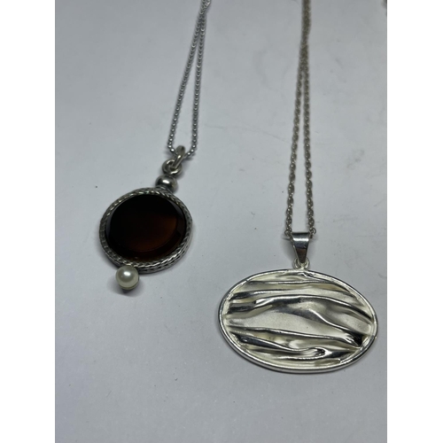 670 - FOUR SILVER NECKLACES WITH PENDANTS