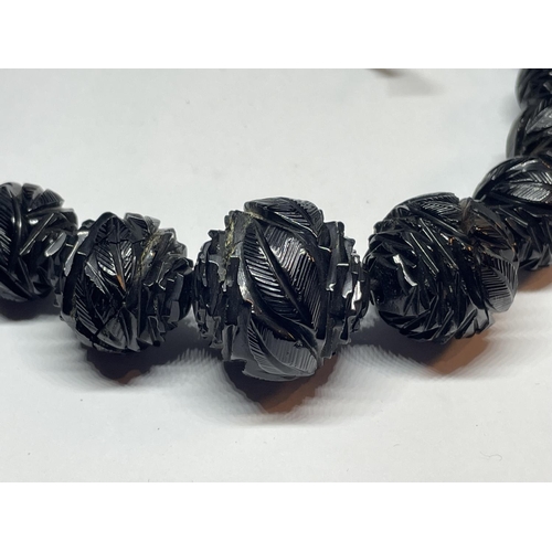 520 - A CARVED WHITBY JET GRADUATED NECKLACE