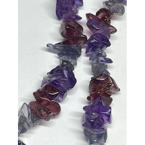 534 - THREE PURPLE STONE ITEMS POSSIBLY AMETHYST TO INCLUDE A BROOCH AND TWO NECKLACES