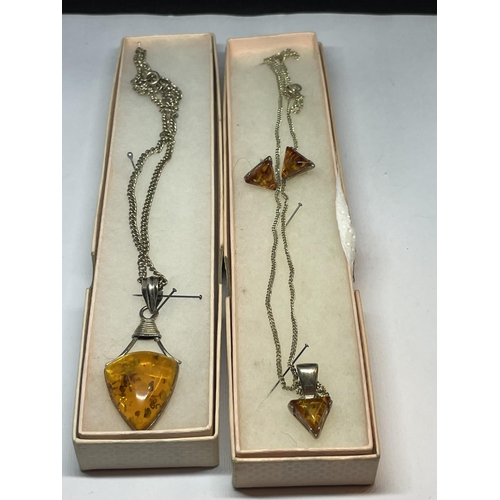 539 - TWO MARKED SILVER PENDANTS WITH AMBER STONES AND A PAIR OF MATCHING EARRINGS IN PRESENTATION BOXES