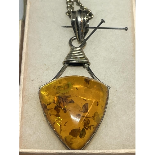 539 - TWO MARKED SILVER PENDANTS WITH AMBER STONES AND A PAIR OF MATCHING EARRINGS IN PRESENTATION BOXES