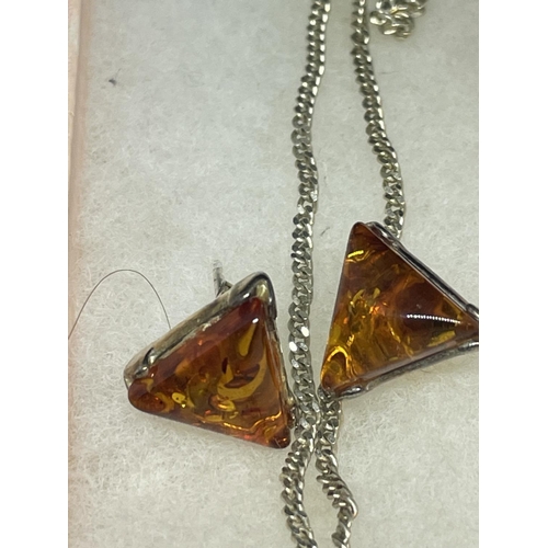 539 - TWO MARKED SILVER PENDANTS WITH AMBER STONES AND A PAIR OF MATCHING EARRINGS IN PRESENTATION BOXES