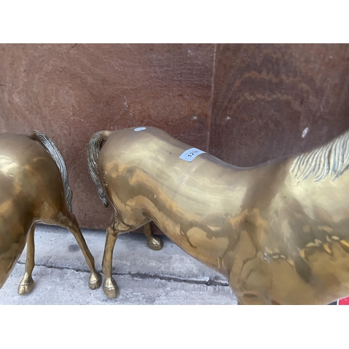 1216 - A PAIR OF LARGE HEAVY BRASS HORSES