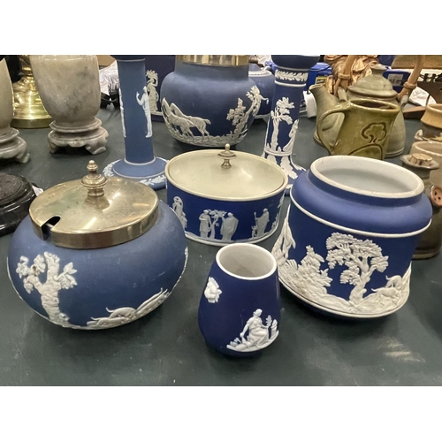 119 - A LARGE QUANTITY OF DARK BLUE JASPERWARE TO INCLUDE LIDDED BISCUIT BARRELS, CANDLESTICKS, A TEAPOT, ... 