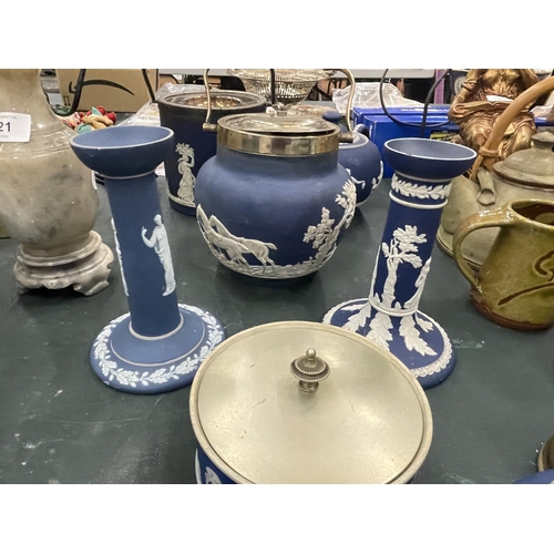 119 - A LARGE QUANTITY OF DARK BLUE JASPERWARE TO INCLUDE LIDDED BISCUIT BARRELS, CANDLESTICKS, A TEAPOT, ... 