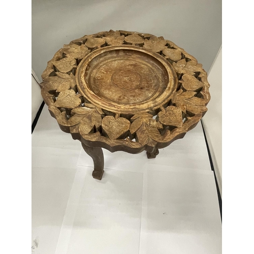 141 - AN ASIAN STYLE SMALL WOODEN TABLE WITH CARVED DECORATION HEIGHT 32CM