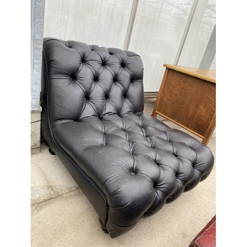 2216 - A 'DISTINCTIVE CHESTERFIELDS' BLACK FAUX LEATHER LOW EASY CHAIR ON TURNED LEGS