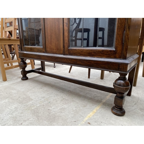 2267 - AN EARLY 20TH CENTURY OAK GLAZED AND LEADED BOOKCASE ON OPEN BASE WITH BULBOUS FRONT LEGS, 41