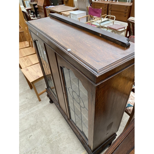 2267 - AN EARLY 20TH CENTURY OAK GLAZED AND LEADED BOOKCASE ON OPEN BASE WITH BULBOUS FRONT LEGS, 41