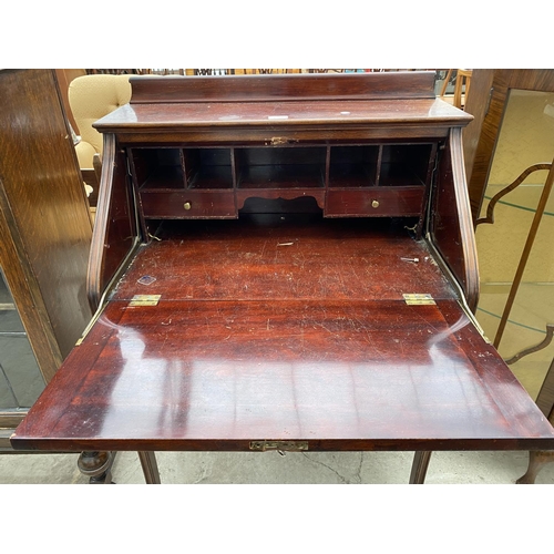 2268 - AN EDWARDIAN MAHOGANY FALL FRONT BUREAU WITH CARVED FLAP ON OPEN BASE, 29