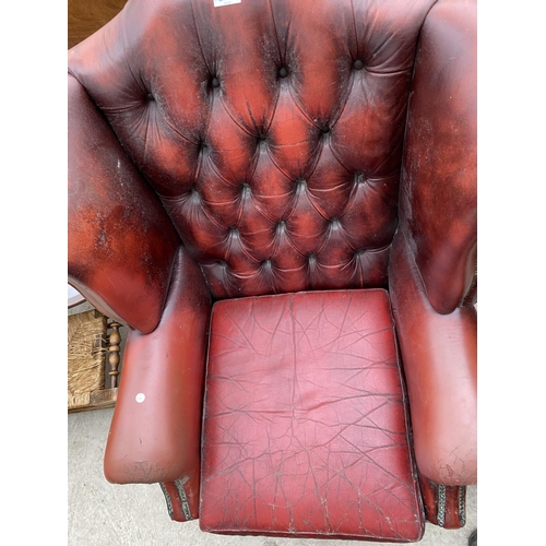 2277 - AN OXBLOOD WINGED BUTTON-BACK FIRESIDE CHAIR, ON CABRIOLE LEGS