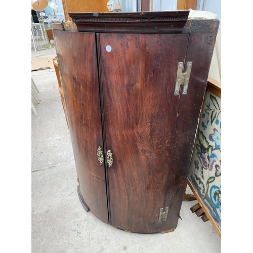 2292 - A GEORGE III MAHOGANY TWO DOOR BOWFRONTED CORNER CABINET WITH FOUR BRASS HINGES, 27