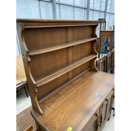 2303 - AN ERCOL DRESSER WITH CUPBOARDS AND DRAWERS TO THE BASE, COMPLETE WITH PLATE RACK, 48