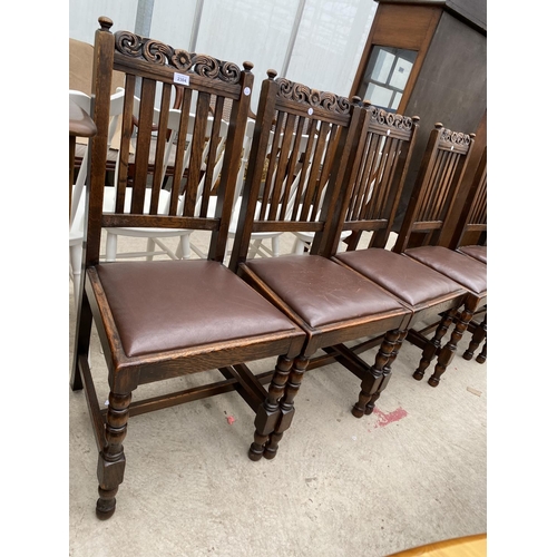 2304 - A SET OF SIX EARLY 20TH CENTURY OAK JACOBEAN STYLE DINING CHAIRS WITH CARVED TOP RAIL AND TURNED LEG... 