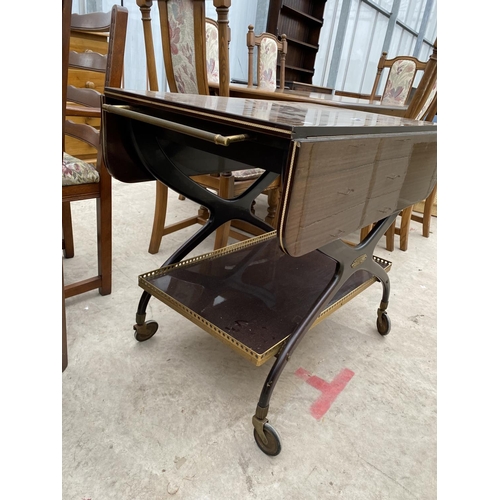 2312 - A 1960'S TWO TIER MAHOGANY TROLLEY ON X-FRAME WITH BRASS GALLERY TO THE LOWER TIER AND BRASS HANDLES