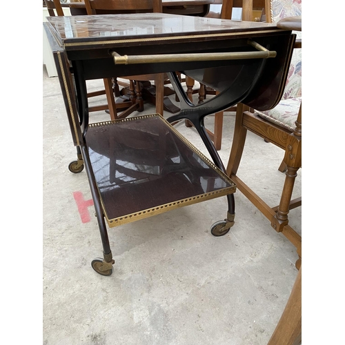 2312 - A 1960'S TWO TIER MAHOGANY TROLLEY ON X-FRAME WITH BRASS GALLERY TO THE LOWER TIER AND BRASS HANDLES