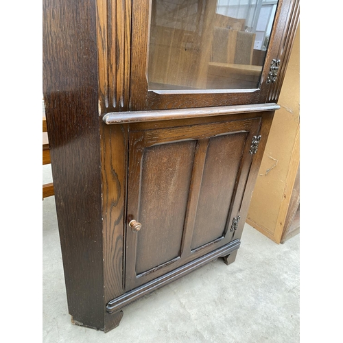 2317 - A MODERN OAK GLAZED CORNER CUPBOARD WITH CUPBOARD TO THE BASE