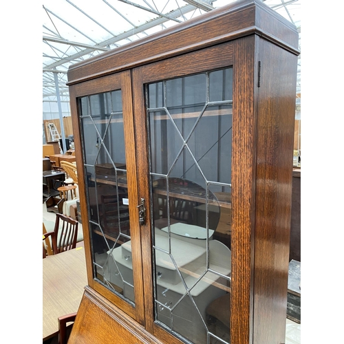 2345 - AN EARLY 20TH CENTURY OAK GLAZED AND LEADED BUREAU BOOKCASE, 32.5