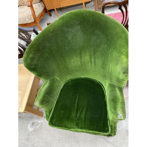 2375 - AN EDWARDIAN GREEN UPHOLSTERED ROUNDED WING-BACK EASY CHAIR ON CASTERS