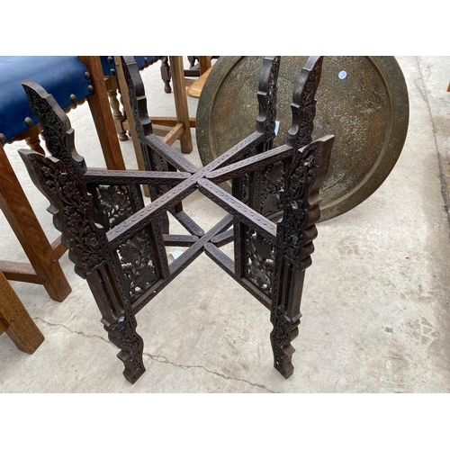 2408 - A 19TH CENTURY INDIAN HARDWOOD FOLDING HEAVILY CARVED TABLE WITH BRASS TOP, COMPLETE WITH ONE OTHER ... 