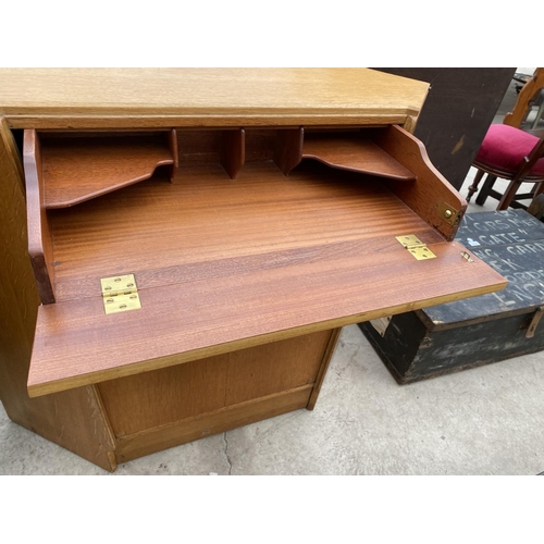 2427 - AN OAK G-PLAN E.GOMME CORNER BUREAU WITH PULL-OUT SECTION AND TWO CUPBOARDS