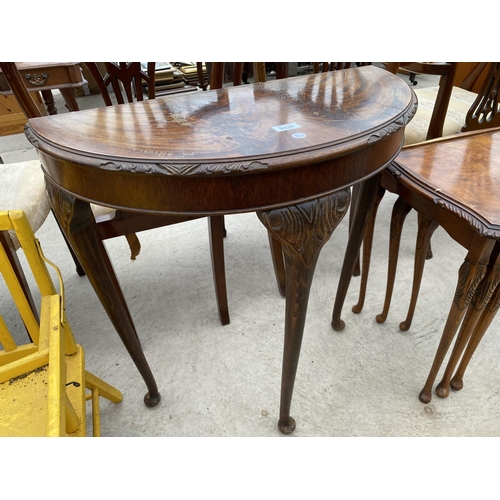 2436 - A NEST OF THREE WALNUT TABLES AND DEMI-LUNE HALL TABLE