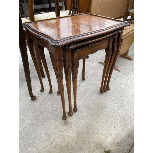 2436 - A NEST OF THREE WALNUT TABLES AND DEMI-LUNE HALL TABLE