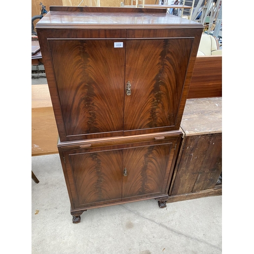 2438 - A MID 20TH CENTURY MAHOGANY COCKTAIL CABINET ENCLOSING THREE SLIDES, PULL-OUT MIRRORED SLIDE, TEN BO... 